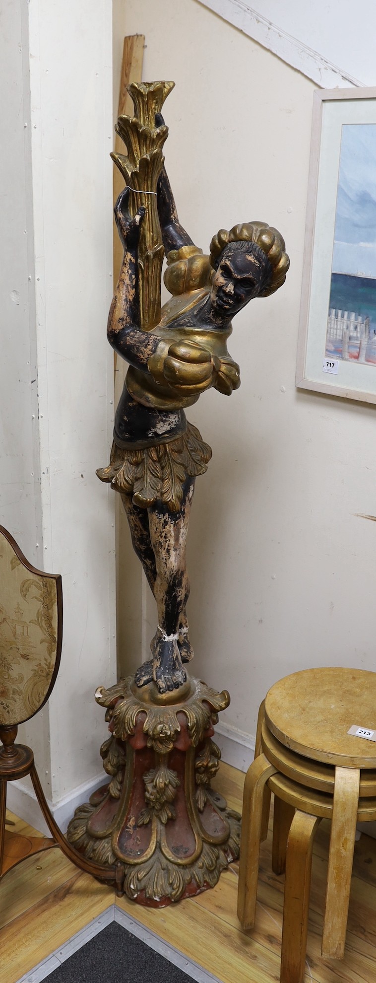A floor standing composition blackamoor, 177cms high